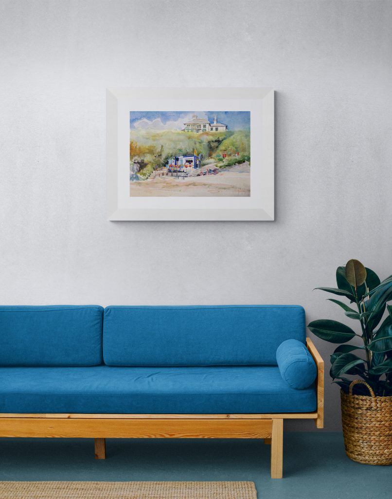 September Barricane art print hanging in a white frame above a blue sofa
