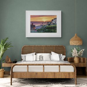 Spring Lundy sunset art print framed and hanging on a green bedroom wall