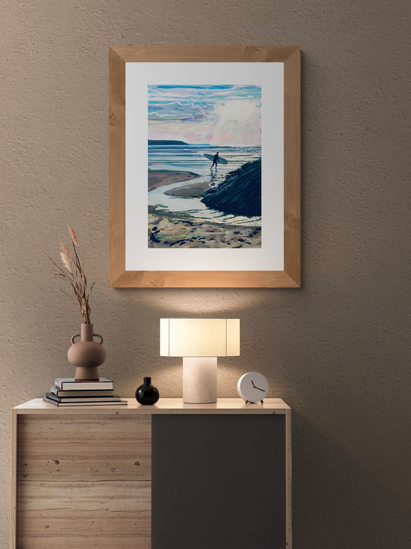 Stepping in surfer Woolacombe print hanging in a lamp lit room