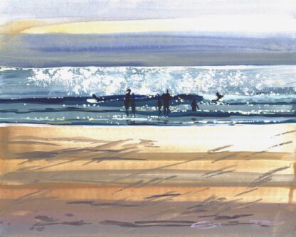 bellyboard surfers sliding across a sparkling wave on Woolacombe beach on a hot summer day