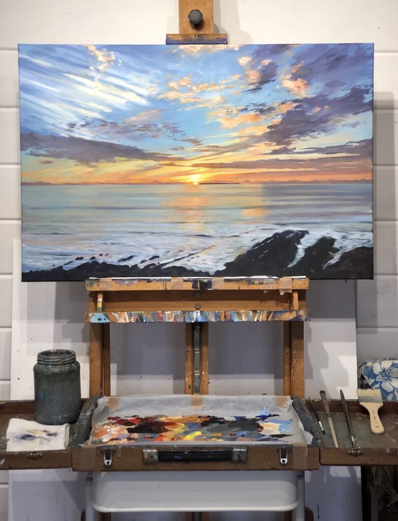 Sunset painting over Lundy Island in North Devon on the easel in artist Steve Pleydell-Pearce's studio