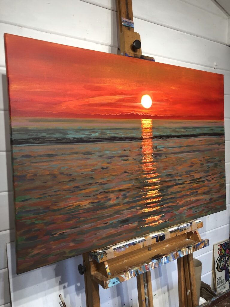 close up of a sunset painting on an artist's easel