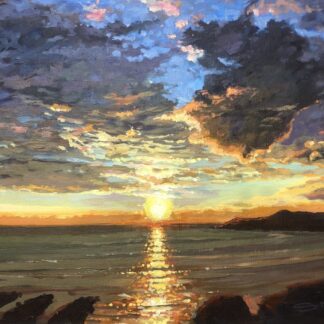 colourful golden sunset with a moody cloudy sky setting over the sea