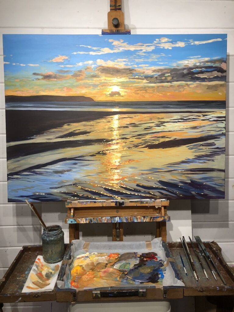 colourful sunset painting on an easel in an artists studio in Devon