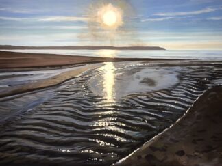 sun sparkling on the sea and stream on Woolacombe beach