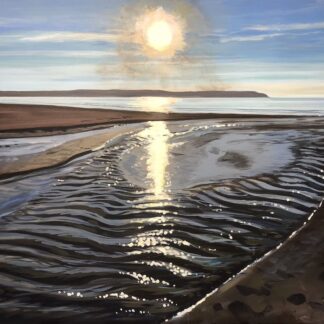 sun sparkling on the sea and stream on Woolacombe beach