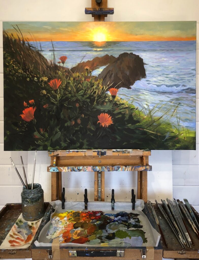 Marigold Sunset Original Barricane Beach Painting by Woolacombe landscape painter Steve PP on an easel in the studio. Colourful orange marigolds line the sea cliffs above Barricane. 