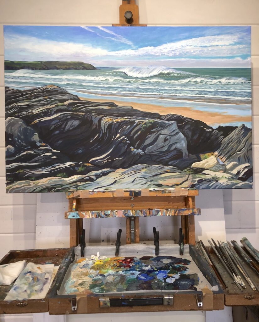 Colourful original painting of sparkling surf breaking in a green sea on a sandy Woolacombe beach, with rocks in the foreground