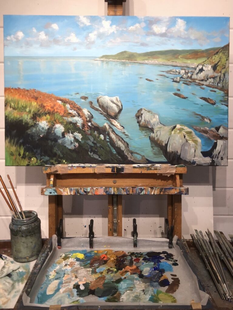 Regional Combesgate Beach painting by Woolacombe landscape painter Steven Pleydell-Pearce on an easel in the art studio