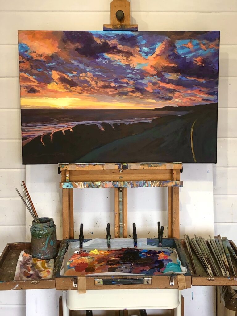 Original Woolacombe Esplandade sunset painting on an easel in the art studio of Woolacombe artist Steve PP